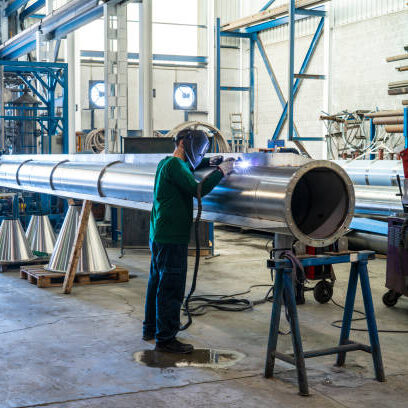 Welder welding stainless steel big pipe at industry workshop Pipe Fabrication